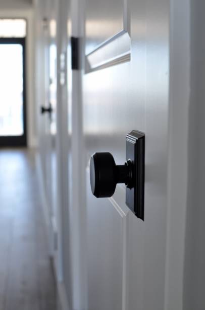 istock Black door knob on white door 651812530