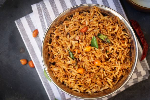 Puliyogare / Tamarind Rice - Tangy and spicy South Indian rice, selective focus Puliyogare / Tamarind Rice - Tangy and spicy South Indian rice, selective focus tangy stock pictures, royalty-free photos & images