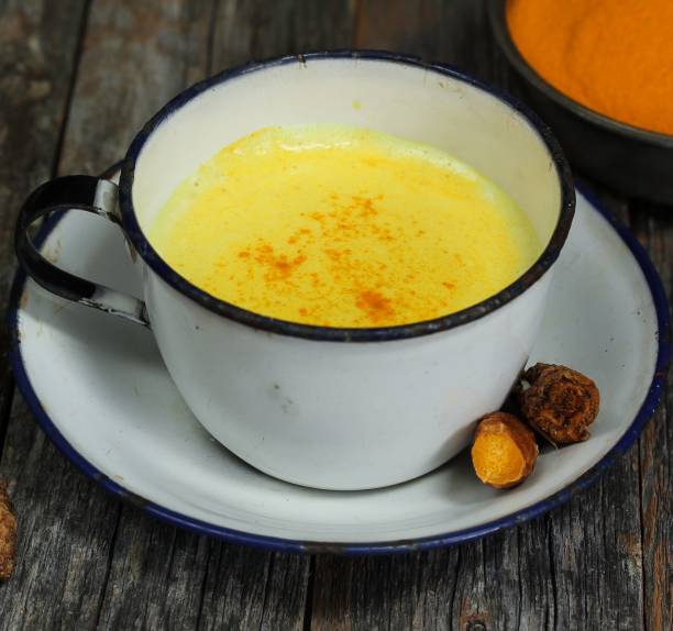 istock Turmeric Drink /  Golden Milk  on dark moody background, selective focus 651857228