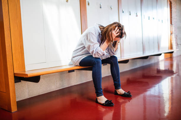 istock Tensed woman sitting in locker room 651858254