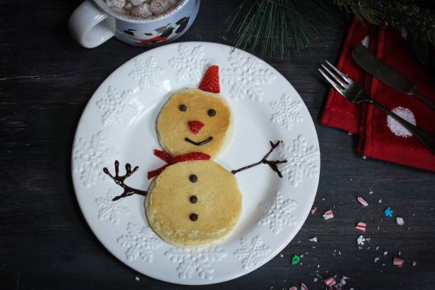 istock Snowman Pancakes for kids on dark moody background 651870490