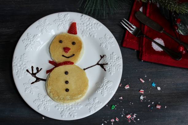 istock Snowman Pancakes for kids on dark moody background 651870744