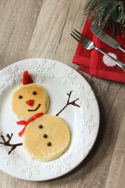istock Snowman pancakes for Christmas breakfast for kids top down view 651871538