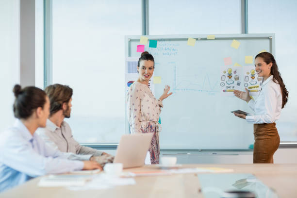 istock Business executives discussing with each other in conference room 651873700