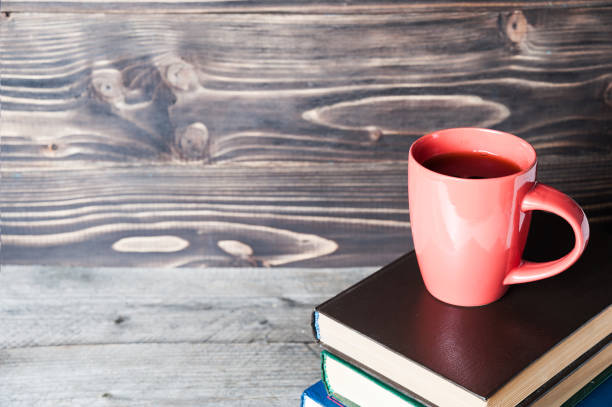 istock Hot coffee or tea, cocoa, chocolate cup on book with copy space for text 651874326