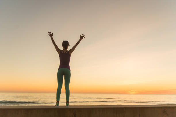 istock Young Women Silhouette Running At Sunset 651876068