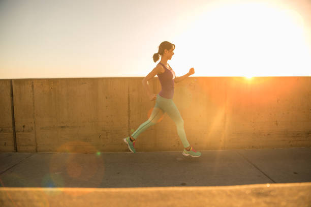 istock Young Women Silhouette Running At Sunset 651876890