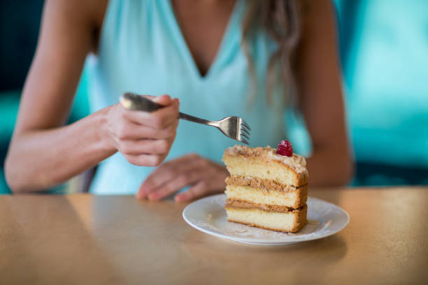 istock Woman eating dessert in cafe 651914080