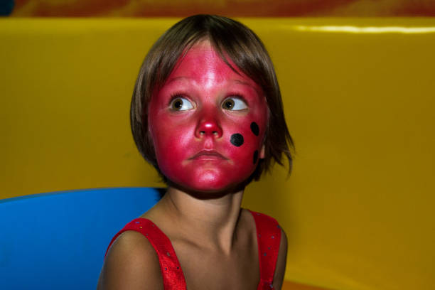 istock Little girl with ladybug face paint 651959716