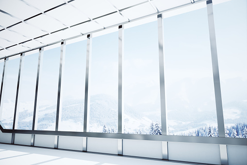 Modern interior with steel windows and panoramic winter landscape view. 3D Rendering