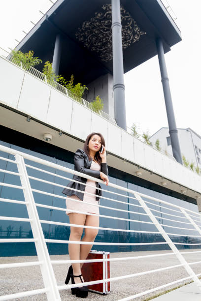 istock business woman talking on mobile smart phone outside 651970120