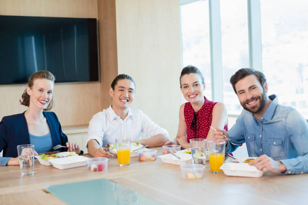 istock Smiling business executive having meal in office 651970492