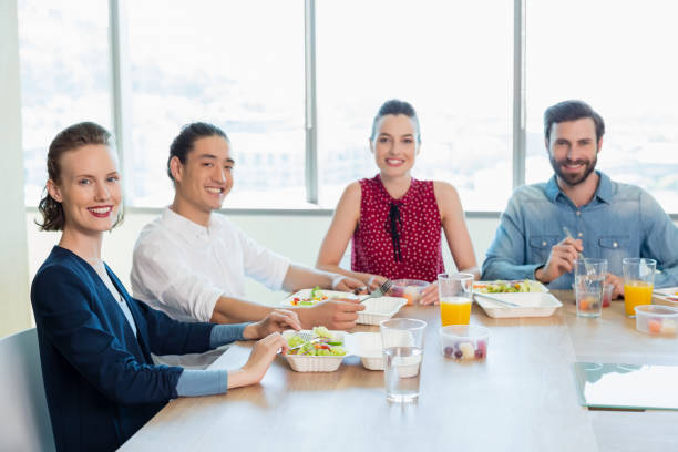 istock Smiling business executive having meal in office 651970522