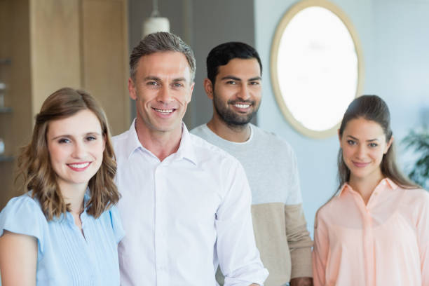 istock Smiling business executives standing together in office 651970542