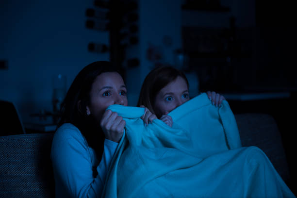 istock Two women watching tv together, horror movie 651970708