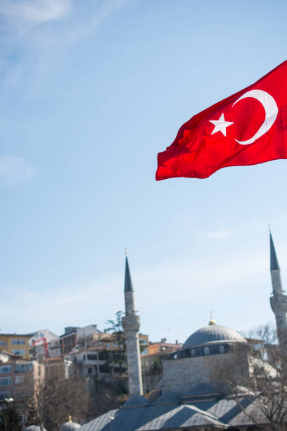istock Turkish national flag  with a minaret behind 651977974