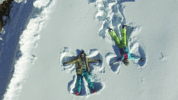 istock Couple making angel silhouette in snow 651982436