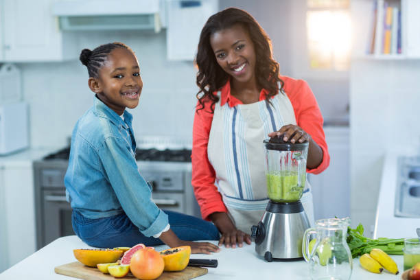 istock Woman and daughter using mixer 652047506