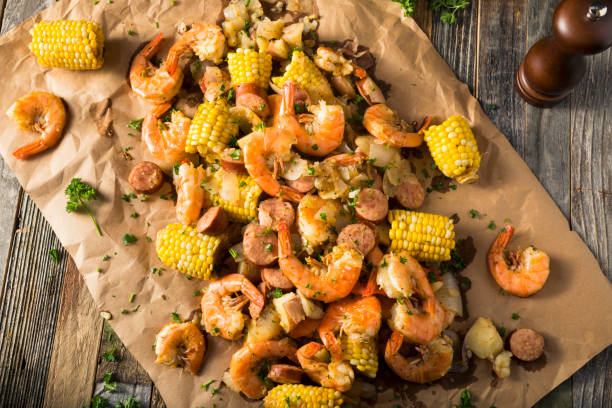 Homemade Traditional Cajun Shrimp Boil Homemade Traditional Cajun Shrimp Boil with Sausage Potato and Corn boiling photos stock pictures, royalty-free photos & images