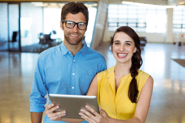 istock Business executive and co-worker holding digital tablet 652118644