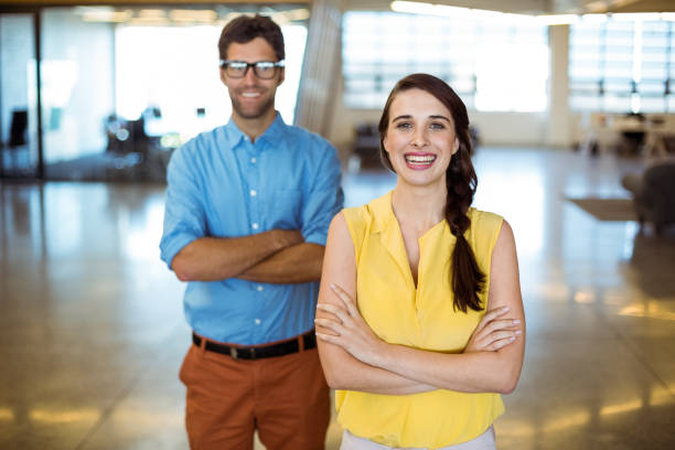 istock Business executive and co-worker standing with arms crossed 652118668