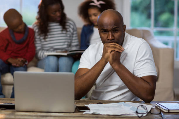 istock Depressed man with bills and laptop 652118718