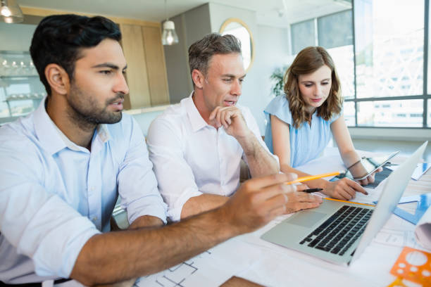 istock Architects discussing over laptop in conference room 652119050