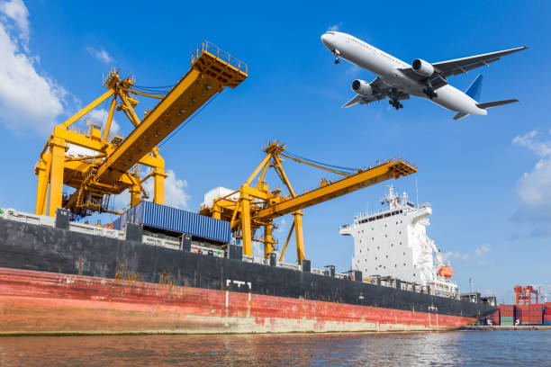 istock Cargo plane flying above ship port for logistic background 652122436