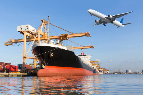 istock Cargo plane flying above ship port for logistic background 652122460