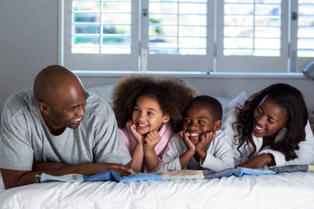 istock Happy family lying on bed 652127554
