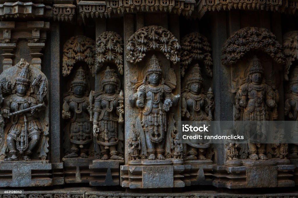 Deity sculpture under eves on shrine outer wall in the Chennakesava temple at Somanathapura, Karnataka,India, Asia The Chennakesava Temple /Chennakeshava located at Somanathapura is one of the finest examples of Hoysala architecture. The temple was built by Soma, a Dandanayaka (lit, "commander") in 1268 C.E. under Hoysala king Narasimha III, when the Hoysala Empire was the major power in South India. Archaeology Stock Photo