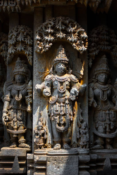 deity sculpture under eves on shrine outer wall in the chennakesava temple at somanathapura, karnataka,india,asia - somnathpur imagens e fotografias de stock