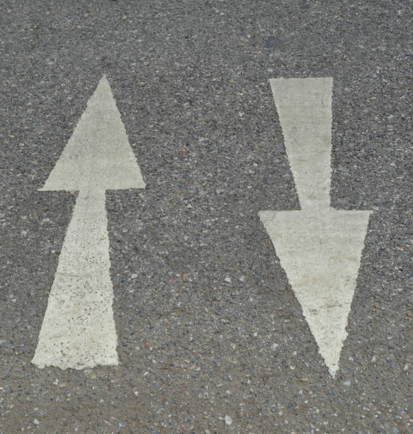 istock White arrow sign on asphalt road 652133892