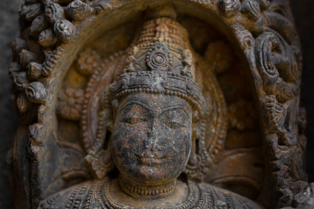 istock Destroyed face of Deity sculpture under eves on shrine outer wall in the Chennakesava temple at Somanathapura,Karnataka,India 652134396