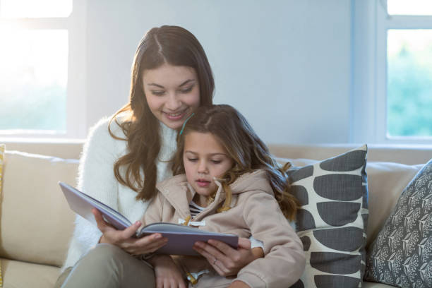 istock Mother and daughter reading a book 652136710
