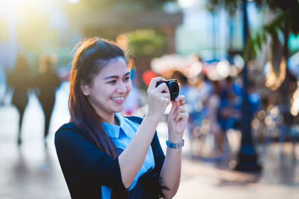 Asia women with camera in free day relax at city Take photo in real place. point and shoot camera stock pictures, royalty-free photos & images