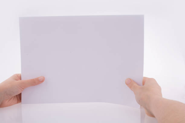 istock Hand holding a white blank sheet of paper 652150678