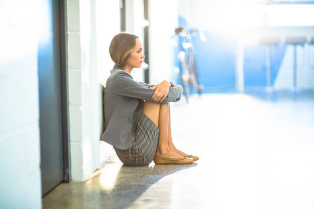 istock Tired businesswoman sitting on office corridor 652151468
