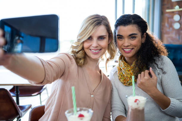 istock Female friends taking a selfie on mobile phone 652158346