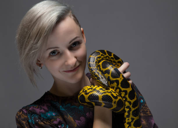 istock Blond smiling woman holding snake 652159372
