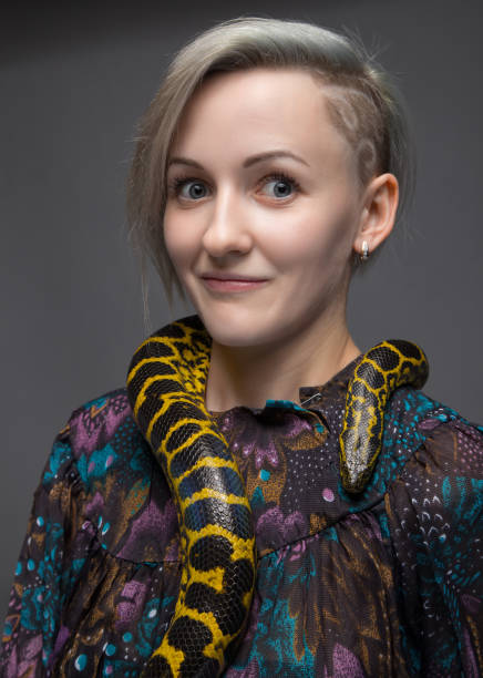 istock Surprised woman and yellow anaconda 652161606