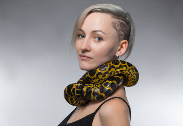 istock Woman with yellow snake on her neck 652161684