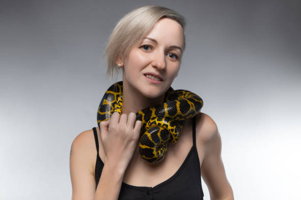 istock Blond woman and strangling snake 652161734