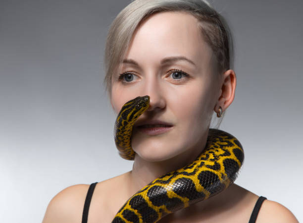 istock Blond woman and crawling snake 652161816