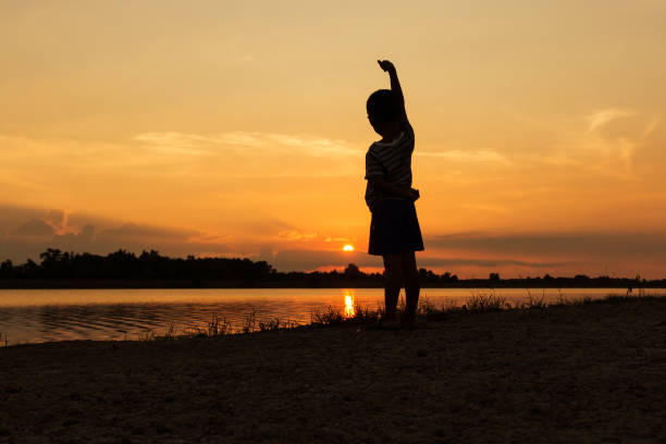 istock Cute little boy play at river sunset background 652162196
