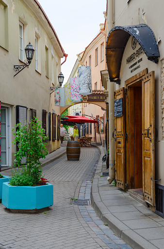 Vilnius, Lithuania - July 10, 2015: Unknown people go near restaurant Naked Bite of Contemporary Cuisine on Stikliu Street in Old Town, Vilnius, Lithuania