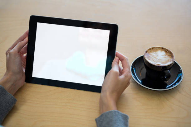 istock Woman using digital tablet with cup of coffee on table 652168032