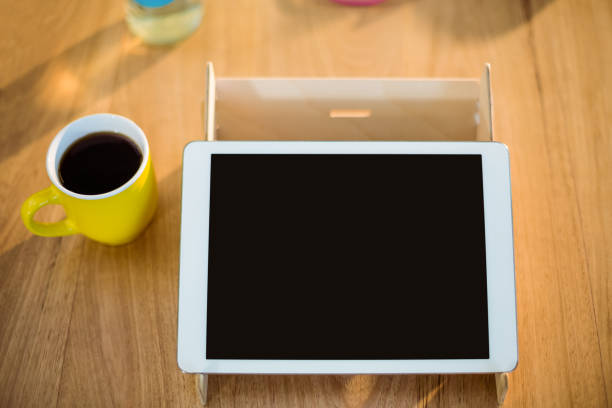 istock Digital tablet and a cup of coffee on table 652172220