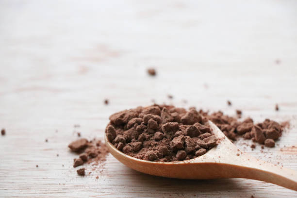istock Cocoa powder in and out the spoon wood 652173100