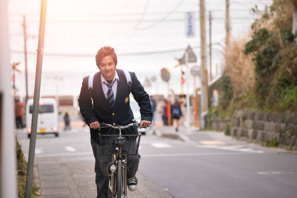 High school boy riding bicycle on slope High school boy riding bicycle on slope shonan photos stock pictures, royalty-free photos & images